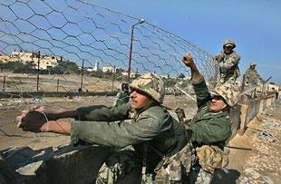 Egyptian soldiers close part of a destroyed section of the border wall between the Gaza Strip and Egypt January 28, 2008.(Xinhua/AFP Photo)