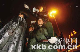 Armed-police soldiers lead the passengers with a loudspeaker at Guangzhou railway station.