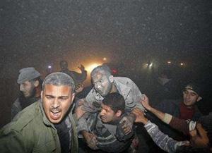 Palestinians evacuate a wounded man after an Israeli missile destroyed the Workers Union headquarters in Gaza February 28, 2008. REUTERS/Mohammed Salem