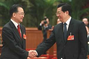 Chinese President Hu Jintao (R) shakes hands with Wen Jiabao after Wen was approved to be premier of China's State Council according to the result of a secret ballot by legislators during the sixth plenary meeting of the First Session of the 11th National People's Congress (NPC) in Beijing, capital of China, March 16, 2008. (Xinhua/Ju Peng)