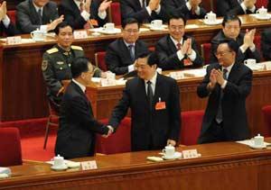 Chinese President Hu Jintao (C front) shakes hands with Wen Jiabao (L front) after Wen was approved to be premier of China's State Council according to the result of a secret ballot by legislators during the sixth plenary meeting of the First Session of the 11th National People's Congress (NPC) in Beijing, capital of China, March 16, 2008. (Xinhua/Li Xueren) 