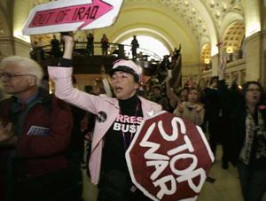 Anti-war activists take part in a protest to mark five years of the war in Iraq during rush hour at Union Station in Washington March 18, 2008. (Xinhua/Reuters Photo)