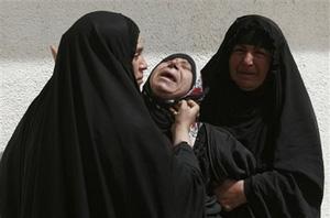 Iraqi family mourns the loss of their relative during a funeral ceremony in the Shiite holy city of Najaf, south of Baghdad, Iraq, Wednesday, April 9, 2008. (AP Photo)