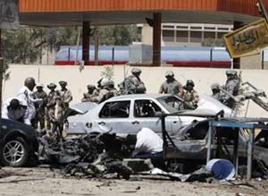 Iraqi and U.S. security forces gather at the scene of a bomb attack in Baghdad April 14, 2008. A blast in central Baghdad's Tayaran Square killed five people and wounded nine, police said. (Xinhua/Reuters Photo)