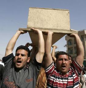 Mourners chant slogans as they carry the coffin of a civilian killed in an air strike during a funeral in Baghdad's Sadr City April 14, 2008. Eight civilians were also wounded in the same air strike, residents said. (Xinhua/Reuters Photo)