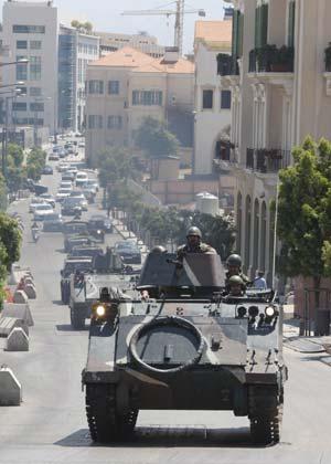 The Lebanese army in armoured personnel carriers advance to deploy in different districts of Beirut May 10, 2008. Hezbollah and its allies will end their armed presence in Beirut after the Lebanese army overturned government measures against the group, an opposition statement said on Saturday.(Xinhua/Reuters Photo)