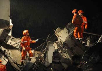 Rescuers work in Dujiangyan city of southwest China's Sichuan Province, on May 13, 2008. A major eathquake measuring 7.8 on Richter scale jolted Wenchuan County of Sichuan Province at 2:28 p.m.on Monday. (Xinhua/Wang Jianhua) 