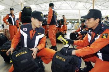 South Korean rescue workers prepare before leaving for Chengdu