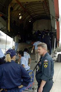 Members of Russian medical team unload relief materials from a chartered plane carrying a Russian medical team in Chengdu, capital of the quake-hit Sichuan province, May 20, 2008. Along with the team arrived a mobile hospital, vehicles and relief materials. Another 36-tonnes of humanitarian assistance materials from Russia will arrive in the city on Tuesday afternoon including medicines weighing 7 tonnes. (Xinhua Photo)