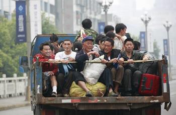 Residents of Nanba Township in Beichuan County sit on a truck returning home from a relief center built in a stadium in Mianyang City, southwest China's Sichuan Province, May 22, 2008. Many residents have left relief centers to rebuild their hometown in recent days. (Xinhua Photo)