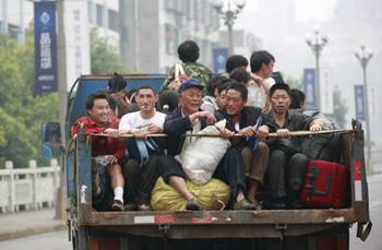 Residents of Nanba Township in Beichuan County sit on a truck returning home from a relief center built in a stadium in Mianyang City, southwest China's Sichuan Province, May 22, 2008. Many residents have left relief centers to rebuild their hometown in recent days. (Xinhua Photo)