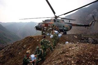 Professionals and materials are airdropped for operations to blow a barrier lake at Tangjiashan, Beichuan County, which was formed by landslides after the May 12 earthquake and now blocks the river Jianhe(Xinhua Photo)