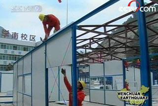 Workers are busy constructing these houses in a middle school. The local government plans to use the houses as dormitories.