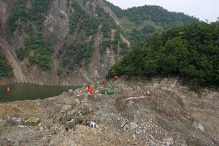The aerial photo taken on May 26, 2008 shows Chinese armed policemen work on the landslide mud that formed the Tangjiashan quake lake near Beichuan County in southwest China's Sichuan Province. The earthquake-induced lake is at risk of bursting and threatening thousands of people downstream. (Xinhua/Zhu Wei)