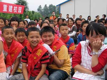 Students smile in a resuming classes ceremony in Chongzhou Hope School in Chongzhou city in southwest China's Sichuan Province, on May 28, 2008. A total of 500 students of Hejia Middle School in Chongzhou resumed their study in the Hope School on Wednesday.(Xinhua/Fu Piyi) 