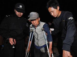 Local police help a man evacuate from quake-hit Mianzhu, southwest China's Sichuan Province, June 4, 2008. More than 14,000 people were to be evacuated by Thursday as potential landslides and mud-rock flows threatened the security of villagers in Hanwang Town in Mianzhu City, Sichuan Province, the local authorities said late Wednesday.(Xinhua Photo)