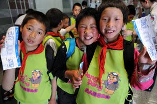 Primary school students pose for a photo before their departure to Shenzhen at the Shuangliu International Airport in Chengdu, southwest China's Sichuan Province, June 4, 2008. A total of 84 pupils and 5 teachers from the quake-hit Wenchuan county headed for Shenzhen in south China's Guangdong Province under the aid of a three-month free studying project.(Xinhua/Song Zhenping)