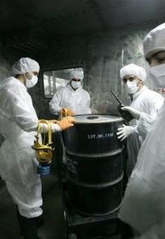 Iranian technicians remove a container of radioactive material from the Uranium Conversion Facilities in Isfahan, Iran, in 2005.(AFP/File/Behrouz Mehri) 