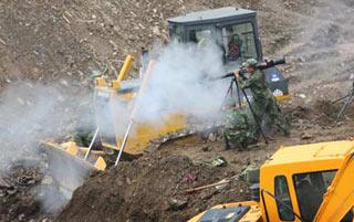 Engineering soldiers fire a missile to blast boulders in a man-made sluice channel in Tangjiashan, quake-hit southwest China's Sichuan Province, June 8, 2008. A total of 4 missiles were fired on Sunday to clear boulders in the sluice channel, which speeded up the drainage of the dangerous Tangjiashan quake lake that began on Saturday morning.(Xinhua Photo)