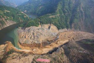 Picture taken at 9 a.m. on June 10, 2008 from a military helicopter shows the drainage of the Tangjiashan quake lake in southewest China's Sichuan Province. Drainage of the quake lake through a manmade spillway speeded up to 1,760 cubic meters per second at 9:30 am on Tuesday, whereas water flow in the lower reaches of the lake, in Beichuan County, reached 2,240 cubic meters per second. (Xinhua/Li Gang)