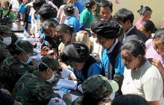 Local residents of the Qiang ethnic group receive medical treatment in Maoxian County, southwest China's Sichuan Province, June 10, 2008. A total of 26 members of a medical team came to Shidaguan village of Maoxian County to help the injured people of Qiang ethnic group there on Tuesday.(Xinhua Photo)