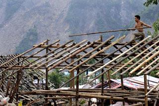 A local man builds house at ruins at Yuzixi Village, Yingxiu Township, Wenchuan County in Southwest China's Sichuan Province, June 9, 2008. Residents in quake-hit Yingxiu Township are now reconstructing their hometown. (Xinhua Photo)