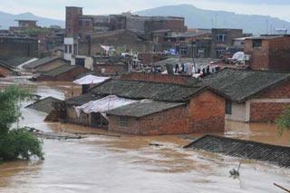 Flooded houses are seen at Luzhai Town in Luzhai County, southwest China's Guangxi Zhuang Autonomous Region, June 13, 2008. Flood caused by heavy rains in the county has left many buildings waterlogged. (Xinhua Photo)