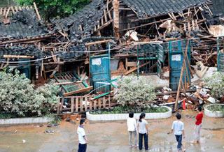 Photo taken on June 15, 2008 shows the flood-damaged student dormitories of Chengdong Middle School in Zhaoping County, southwest China's Guangxi Zhuang Autonomous Region. Some 15 dormitories of the school were destroyed by flood on June 14. (Xinhua Photo)