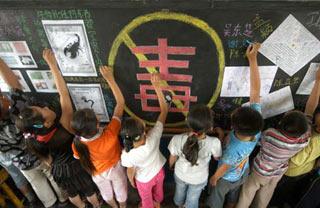 Pupils write their signatures on the blackboard with anti-drug design at the Beiguanjie Elementary School of Xingtai City, north China's Hebei Province, June 25, 2008. The elementary and middle schools in Xingtai City hold drug ban activities on the theme of Creating Drug-Free Campus to mark the International Day Against Drug Abuse and Illicit Trafficking which falls on June 26. (Xinhua/Huang Tao)