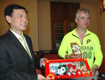 Zhang Lirong (L), counselor of the Embassy of the People's Republic of China in London presents a gift to a representative of police from China Town in Birmingham, June 30, 2008. (Xinhua Photo)