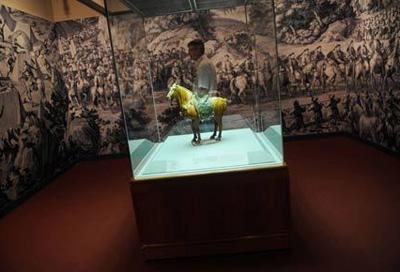 A visitor views exhibits at the "Story of the Horse" exhibition in Hong Kong, south China, on June 27, 2008. About 40 exhibits were displayed in the six-month exhibition for the celebration of Hong Kong's co-hosting of the Equestrian Events of the Beijing 2008 Olympic Games, to be held in August. [Photo: Xinhua]