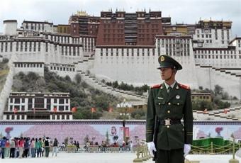 A Chinese policeman stands guard in front of the Potala palace in Lhasa in mid June.