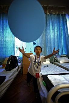 Ma Xiaobo, a student from Bailu Township of Pengzhou City in southwest China's Sichuan Province play with a ballon in his dormitory at a summer camp in Tuapse, a city on Russia's Black Sea coast, July 19, 2008. A group of 184 students from China's earthquake-hit province of Sichuan arrived at the summer camp on July 19 for a three-week rehabilitation visit.(Xinhua Photo)