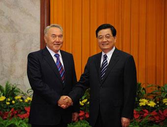 Chinese President Hu Jintao (R) shakes hands with President of Kazakhstan Nursultan Nazarbayev during their meeting in Beijing, China, Aug. 7, 2008. Nursultan Nazarbayev is here to attend the opening ceremony of the Beijing Olympic Games and other events. (Xinhua)