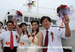 A total of 19 pairs of newlyweds from 12 cities of China hold a romantic group wedding on the sea in Olympic co-host city Qinhuangdao, north China's Hebei Province, at about 11:00 a.m. on Aug. 8, 2008, 9-hour countdown to the opening ceremony of the Olympics. The opening ceremony of the Beijing 2008 Olympic Games will be held in the National Stadium at 8:00 p.m. on Aug. 8. (Xinhua/Gong Zhihong)