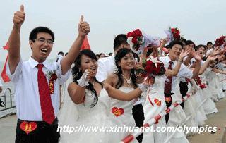 A total of 19 pairs of newlyweds from 12 cities of China hold a romantic group wedding on the sea in Olympic cohost city Qinhuangdao, north China's Hebei Province, at about 11 a.m. on Aug. 8, 2008, 9 hour countdown to the opening ceremony of the Olympics.(Xinhua/Gong Zhihong)