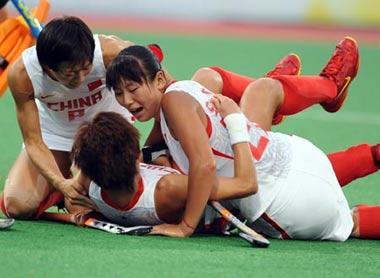 Chinese hockey players celebrate after making a goal during the women's semifinal match between China and Germany of Beijing Olympic Games hockey event in Beijing, China, Aug. 20, 2008. China beat Germany 3-2 and advanced to the final. (Xinhua Photo)