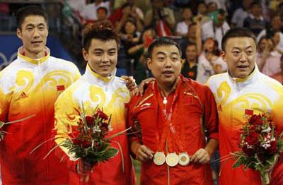 Gold medallists Ma Lin (R), Wang Hao (2nd L) and Wang Liqin (L) of China celebrate with their coach after winning their men's team table tennis final against Germany at the Beijing 2008 Olympic Games August 18, 2008.