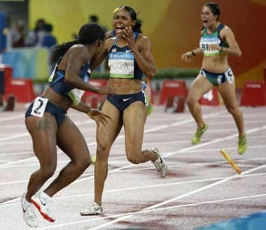 Torri Edwards (L2) reacts as her teammate Lauryn Williams (L1) lost the baton during the women's 4x100m relay first round at the National Stadium, also known as the Bird's Nest, during Beijing 2008 Olympic Games in Beijing, China, Aug. 21, 2008. (Xinhua/Liao Yujie)