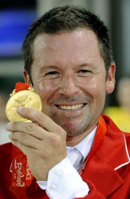 Eric Lamaze of Canada poses with his gold medal after winning the equestrian individual show jumping final of the 2008 Beijing Olympic Games with his horse "Hickstead" on August 21, 2008 in Hong Kong. Rolf-Goran Bengtsson of Sweden, riding Ninja, took the silver with Beezie Madden, riding Authentic for the USA, winning the bronze.