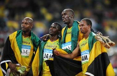 Asafa Powell, Nesta Carter, Usain Bolt and Michael Frater (From L to R)of Jamaica pose for photos after the men's 4x100m relay final at the National Stadium, also known as the Bird's Nest, during Beijing 2008 Olympic Games in Beijing, China, Aug. 22, 2008. The Jamaican team won the title with 37.10 seconds and set a new world record.(Xinhua Photo)