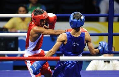 Somjit Jongjohor(blue) of Thailand competes during Men's Fly (51kg) Final Bout between Andris Laffita Hernandez of Cuba and Somjit Jongjohor of Thailand of Beijing 2008 Olympic Games boxing event at Workers' Gymnasium in Beijing, China, Aug. 23, 2008. Somjit Jongjohor defeated Andris Laffita Hernandez 8-2, and won the gold medal of the event. (Xinhua Photo)
