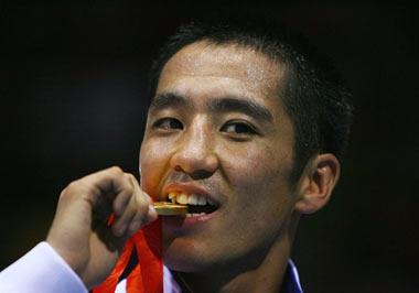 Badar-Uugan Enkhbat celebrates with his gold medal. (Photo credit: Al Bello/Getty Images)