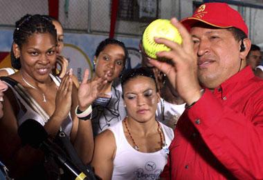 Venezuelan President Hugo Chavez (R) holds a signed ball given to him by the Venezuelan Olympic softball team during the Sunday broadcast of "Alo President" in Petare, Aug. 24, 2008.  (Xinhua/Reuters Photo)
