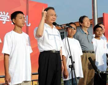 Chinese Premier Wen Jiabao (2nd L) speaks during the opening of the temporary site of Beichuan Middle School located in the courtyard of the Changhong training center in Mianyang, China's quake-hit Sichuan Province, Sept. 1, 2008. A new semester started on Monday. (Xinhua Photo) 