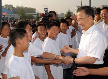 Chinese Premier Wen Jiabao (R front) attends the opening of the temporary site of Beichuan Middle School located in the courtyard of the Changhong training center in Mianyang, China's quake-hit Sichuan Province, Sept. 1, 2008. A new semester started on Monday. (Xinhua Photo) 