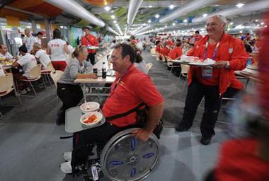 Athletes have their meals in the dining hall of the Paralympic village in Beijing, China, Aug. 30, 2008. The Paralympic village officially opened to athletes from all over the world on Saturday for the Beijing Paralympic Games. (Xinhua/Li Wen)