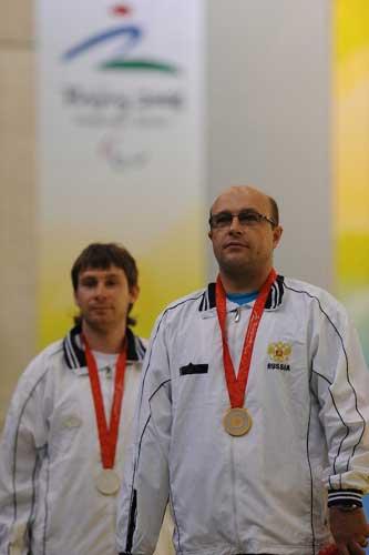 Valeriy Ponomarenko (R) poses on the podium.