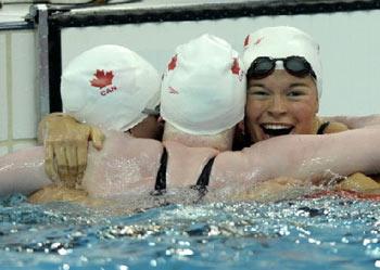 Valerie Maison Grand (R) of Canada celebrates with teammates Chelsey Gitell (C) and Cote Kirby (L) after winning the gold medal in the women's 100m butterfly S13 final during the 2008 Beijing Paralympic Games at the National Aquatic Center also known as the water cube in Beijing, September 7, 2008. 