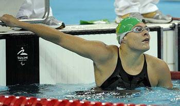 Natalie du Toit of South Africa looks at the result board after winning the women's 100m butterfly S9 final during the 2008 Beijing Paralympic Games at the National Aquatics Center in Beijing on September 7, 2008. South Africa's Du Toit, who finished 16th in the Olympics women's 10 kilometres swim, shaved almost half-a-second off her previous mark in the 100m butterfly heats on the first day of competition.Agencies] 